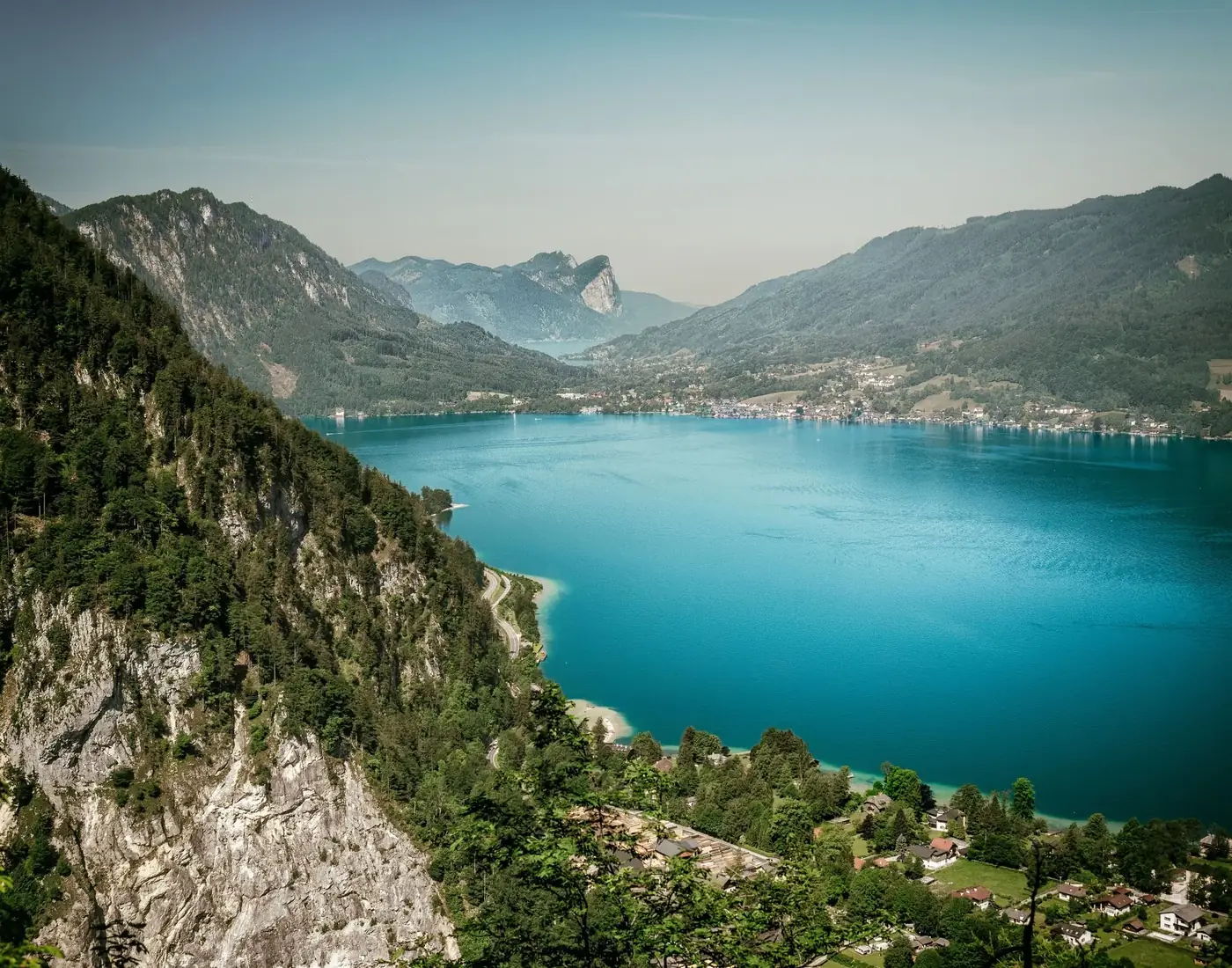 Stunning aerial view of Attersee Lake surrounded by lush mountains in Austria.