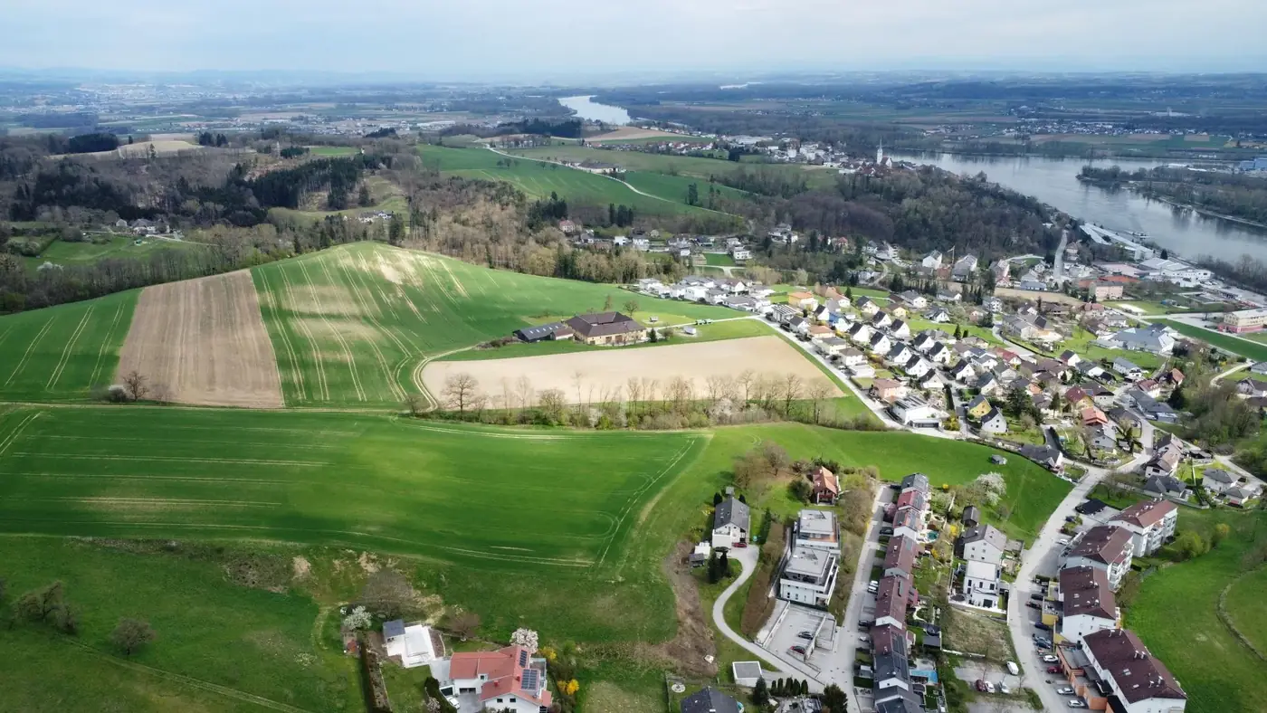 Stunning aerial shot of Mauthausen, Austria featuring lush fields and the Danube River.
