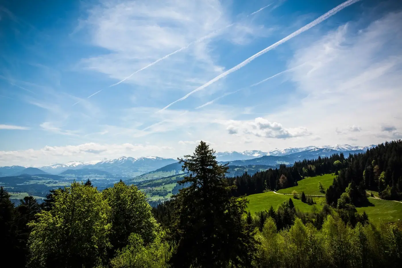 Scenic view of the mountains and valleys in Bregenz, Austria under a clear blue sky.
