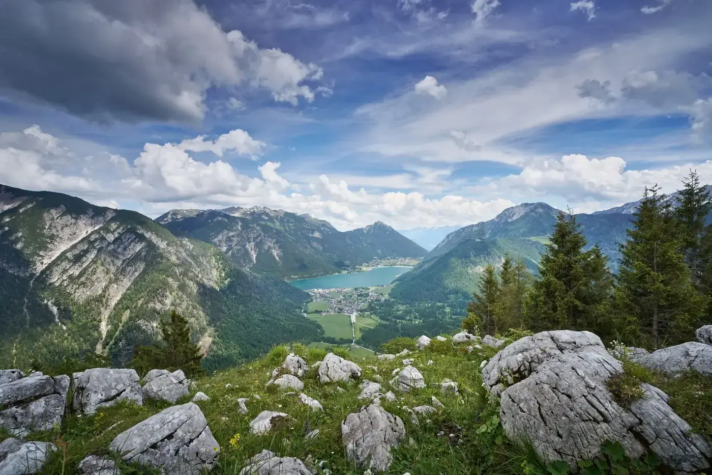 Majestic view of Pertisau in Tirol, Austria, with lush valleys and alpine lakes.