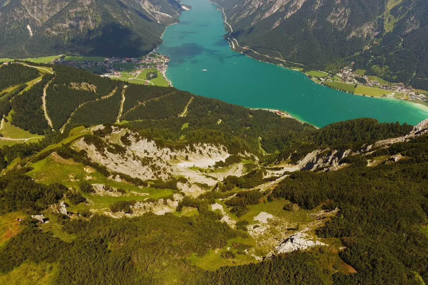Stunning aerial shot of Achensee Lake and surrounding Alpine landscape in Tyrol, Austria.
