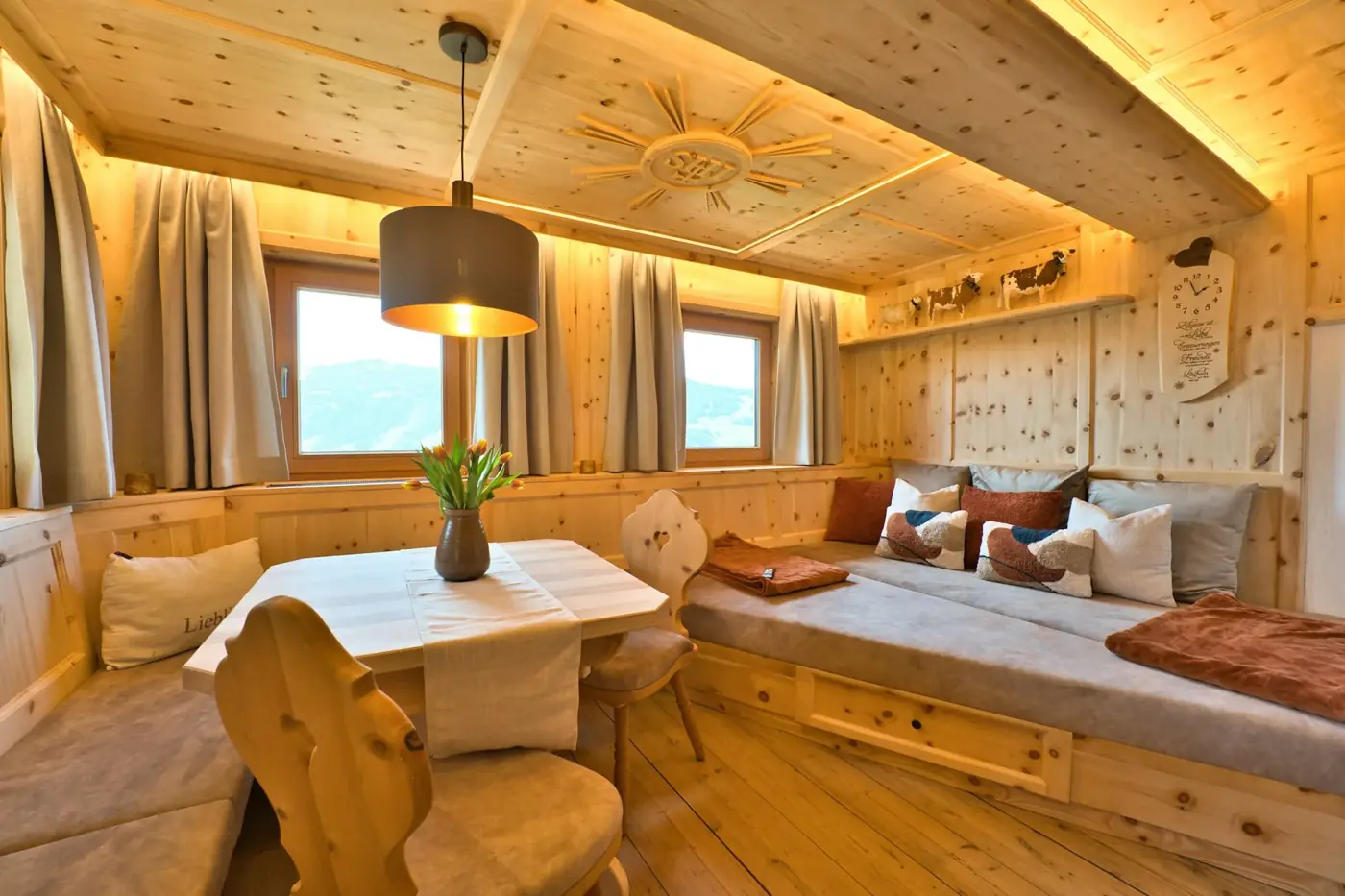 Cozy wooden room with seating and dining area