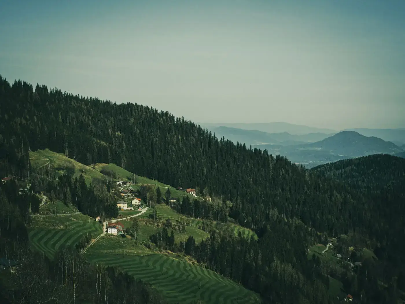 A stunning aerial shot of Carinthian villages nestled in lush green hills, showcasing scenic landscapes.