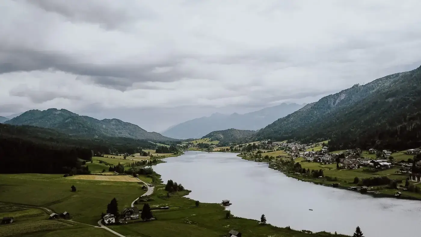 Stunning aerial view of Weißensee lake and surrounding landscape in Carinthia, Austria.
