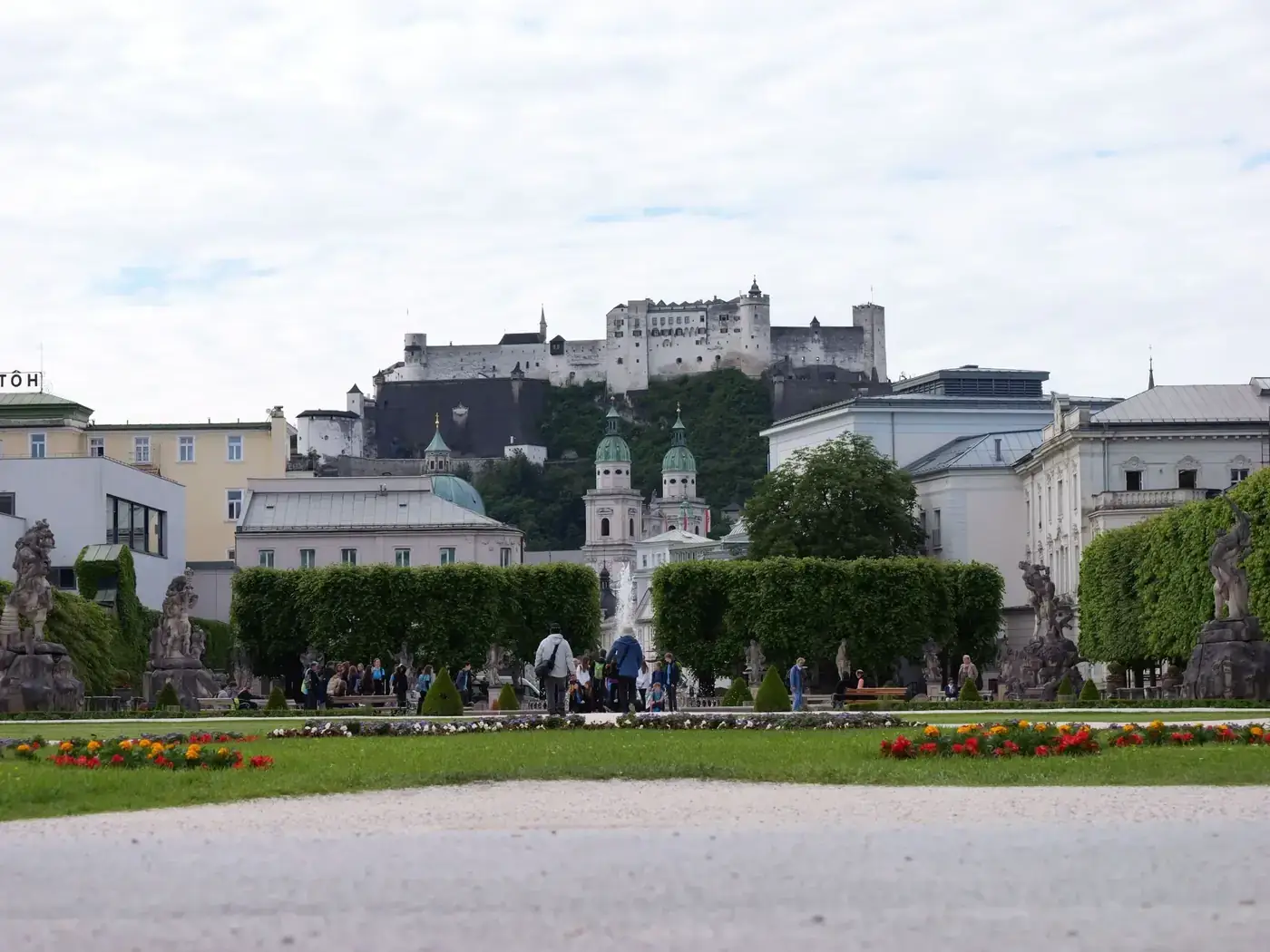 View of Hohensalzburg Castle from Mirabell Gardens in Salzburg. A blend of historical architecture and nature.