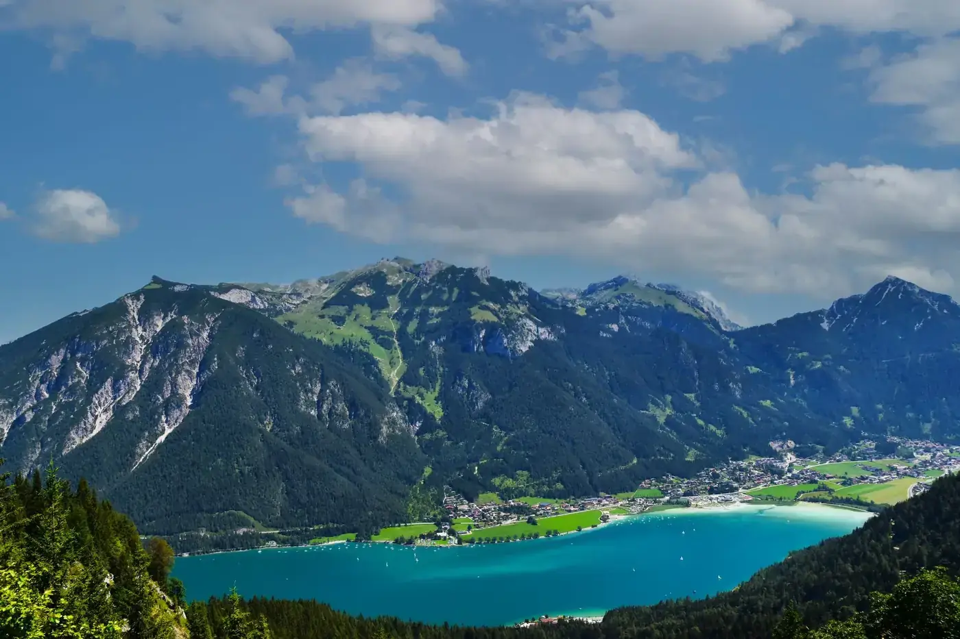 Stunning view of Achensee Lake and mountains in Tirol, Austria, under a clear blue sky.