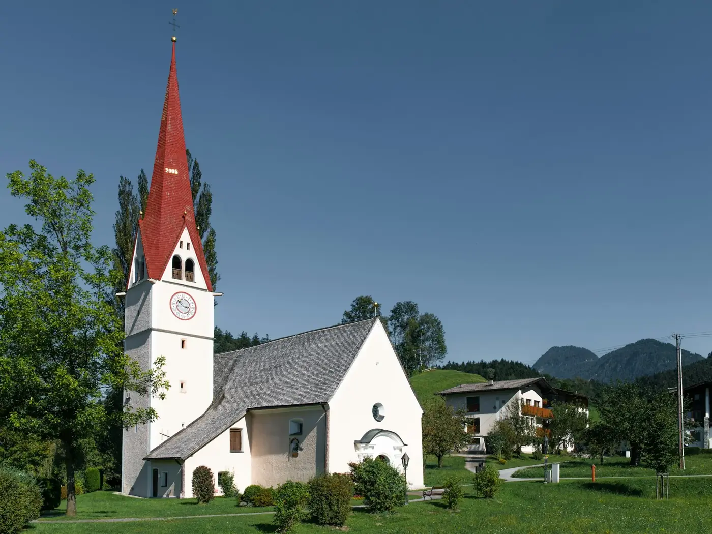 A church with a red steeple stands tall