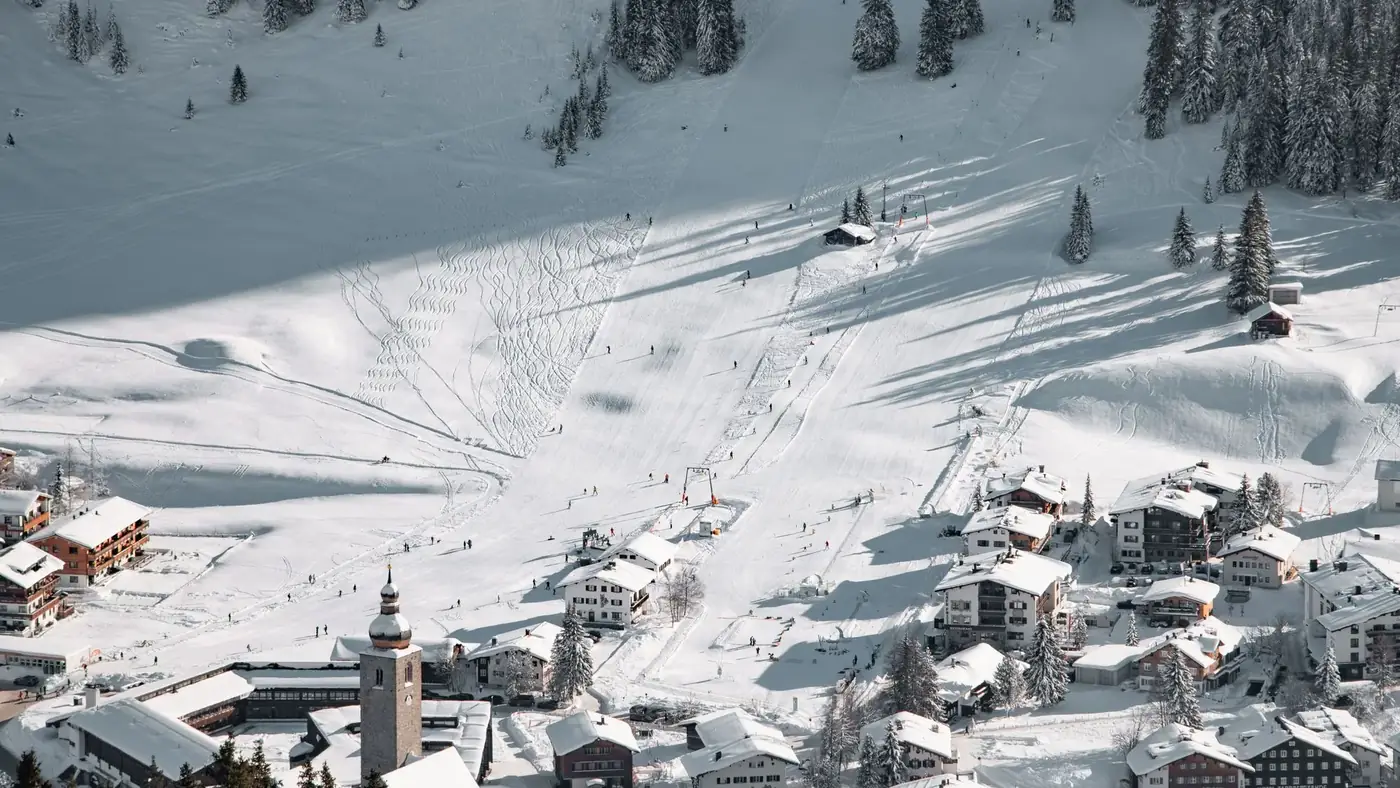 A beautiful aerial view of snowy ski slopes and village in Lech am Arlberg, Austria.