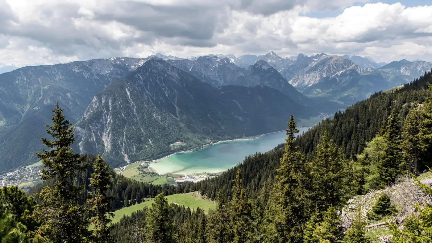 A breathtaking aerial view of Achensee Lake surrounded by majestic mountains in Tirol, Austria.
