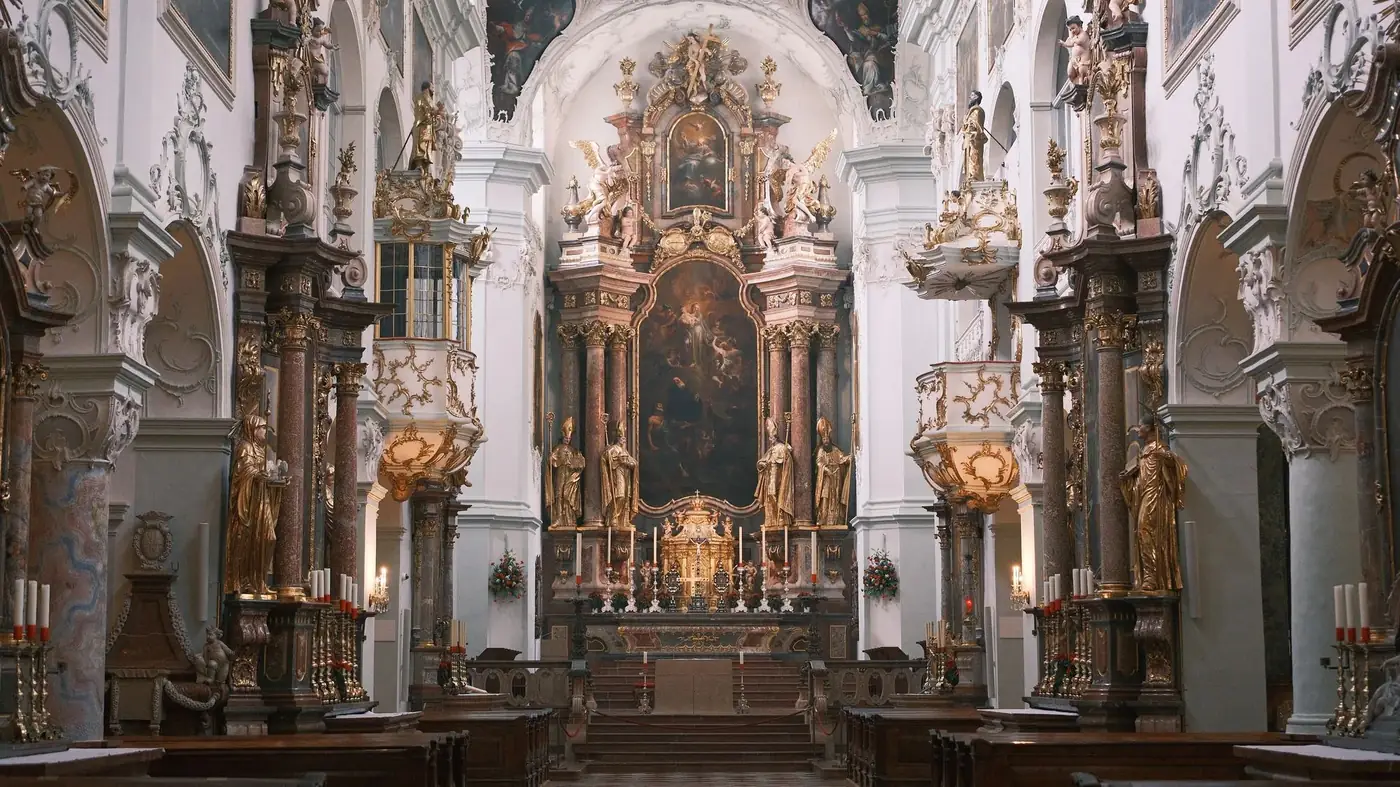 Stunning baroque church interior in Vienna, showcasing ornate altar and sculptures.