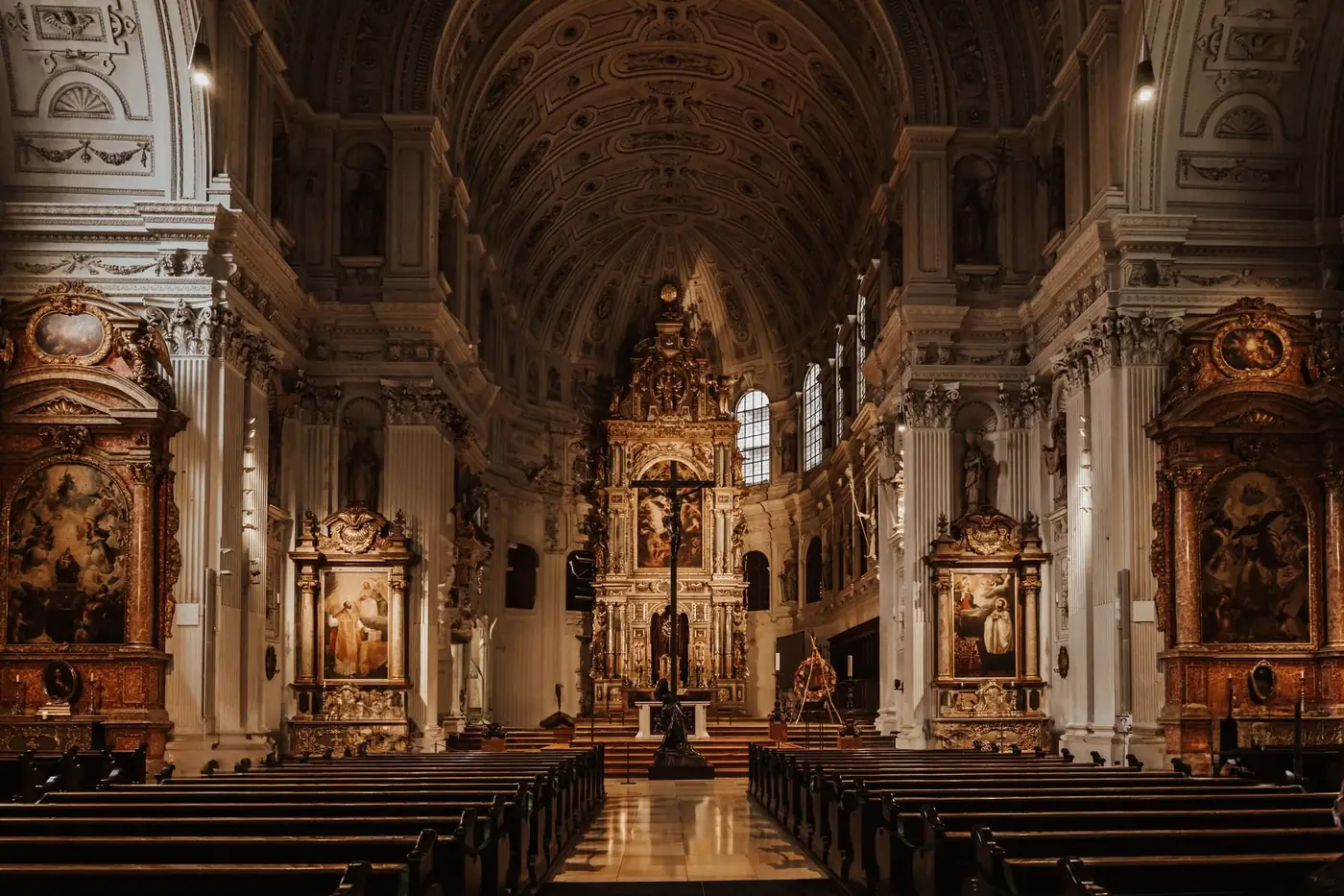 Explore the intricate Baroque interior of St Michael's Church in Munich, highlighting its symmetrical design and histori