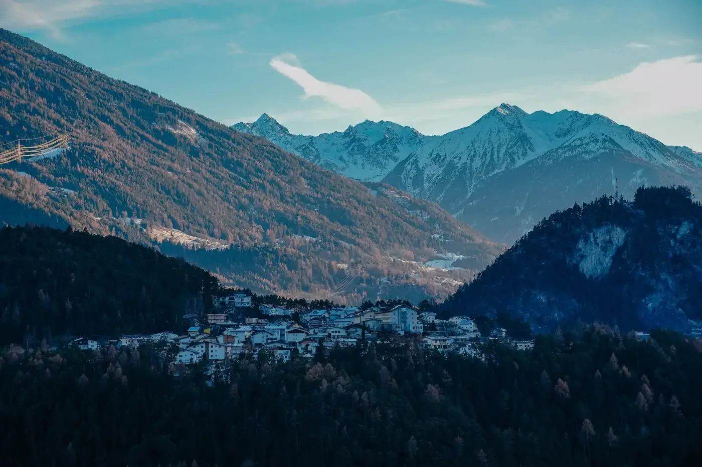Captivating landscape of Imst, Tyrol with surrounding snow-covered peaks under a clear sky.
