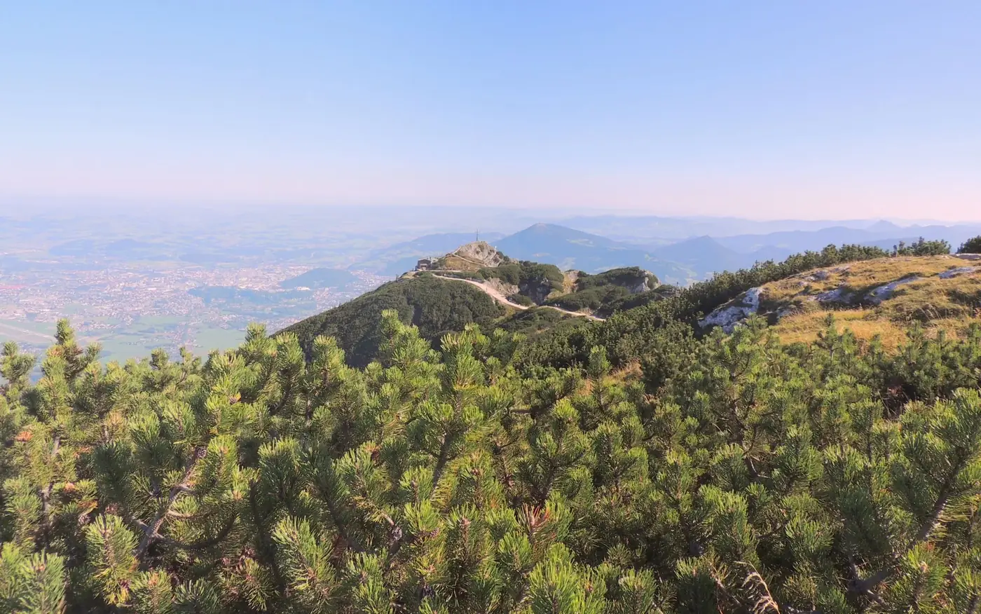 Explore the stunning alpine landscape and distant Salzburg skyline from the top of Untersberg.