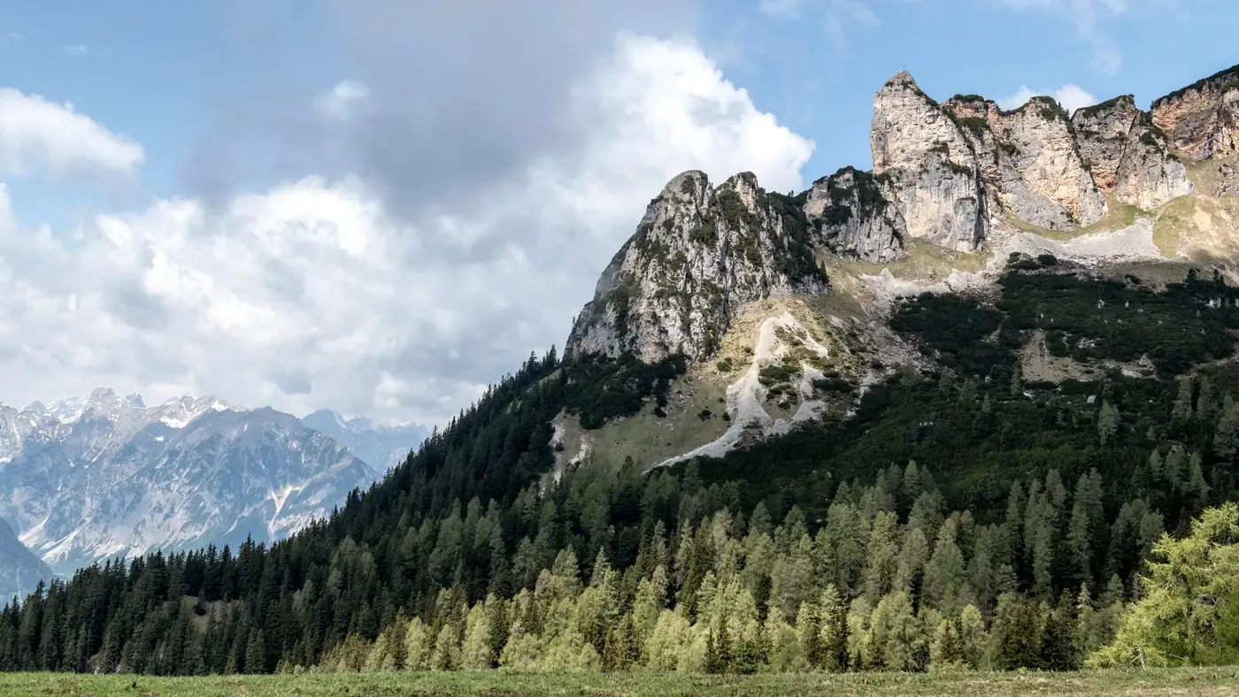 Breathtaking view of rugged mountains and lush forests at Achensee, Tirol, Austria.